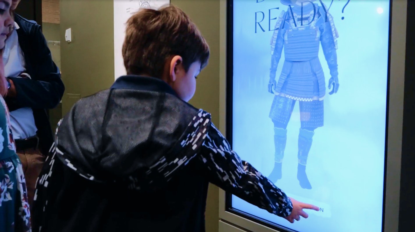 A boy configuring his warrior's armor at the READY screen
