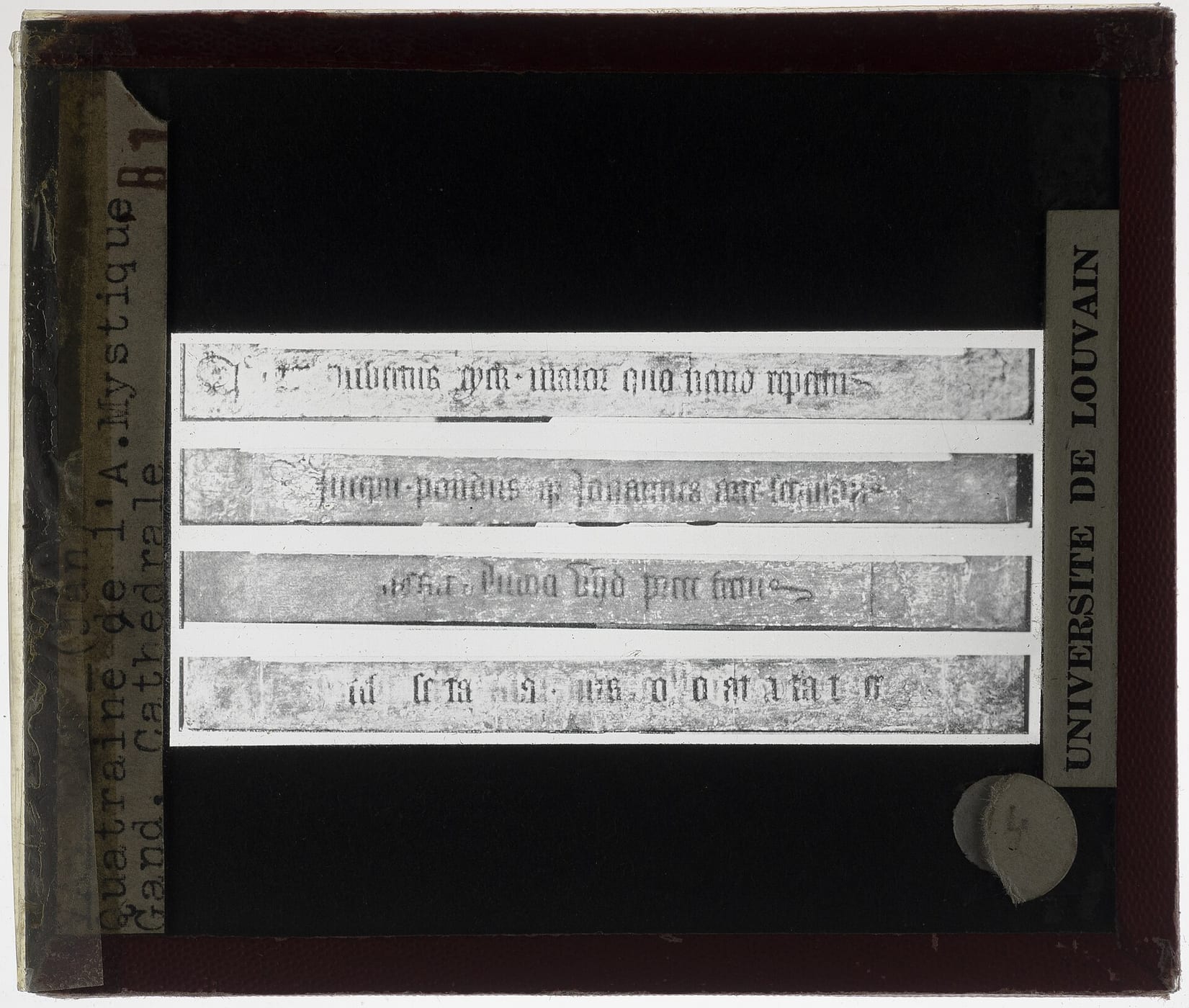 Glass lantern slide showing four strips of Latin text from the Ghent Altarpiece’s frame.
